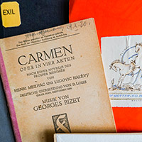 Exlibris von Gottfried Bermann, im Vordergrund eine ältere Ausgabe der Publikation „Carmen. Oper in vier Akten“
