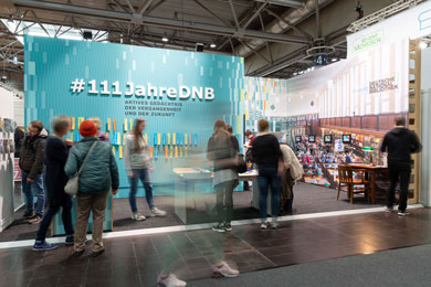 Exhibition stand of the German National Library. Visitors take a look at what is on offer.