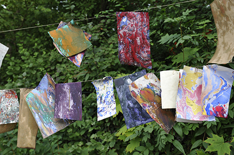 Coloured papers hanging on a line to dry