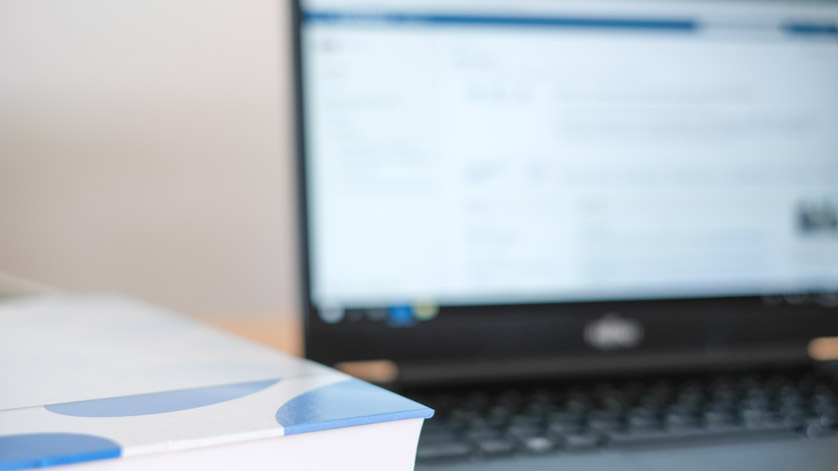 Symbol for practical standardization work: A closed book (a set of rules?) and a notebook on a table Symbol for practical standardization work: A closed book (a set of rules?) and a notebook on a table
