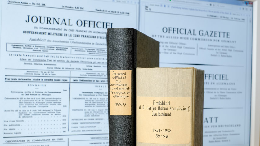 Two bound journal volumes, in the background a computer monitor with display of the digital copies Two bound journal volumes, in the background a computer monitor with display of the digital copies