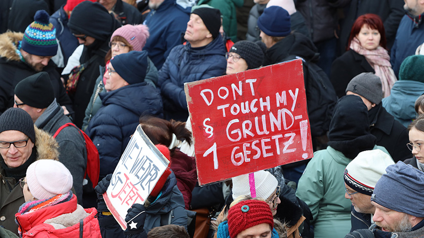 Crowd of people; in the centre a red sign with the inscription DONT TOUCH MY CONSTITUTION § 1 is held up. Crowd of people; in the centre a red sign with the inscription DONT TOUCH MY CONSTITUTION § 1 is held up.