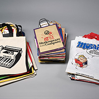 Three stacks of different book bags, including: One from the comic magazine "Mosaik" and one from the bookshop "Shakespeare and Company".  Three stacks of different book bags, including: One from the comic magazine "Mosaik" and one from the bookshop "Shakespeare and Company".