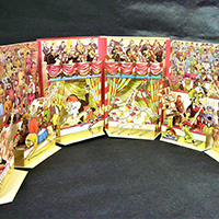 Pop-up picture of a circus ring showing various performances with music.
